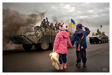 Ukraine war and children waving to army 