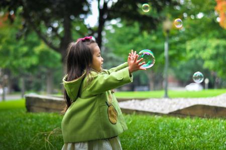A girl playing with bubbles