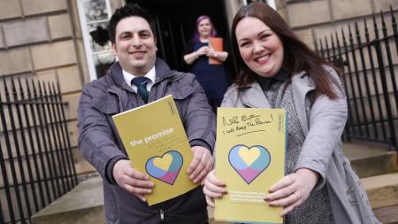 Two personf holdin The Promise Scotland document